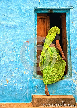 Indian woman entering the door Stock Photo