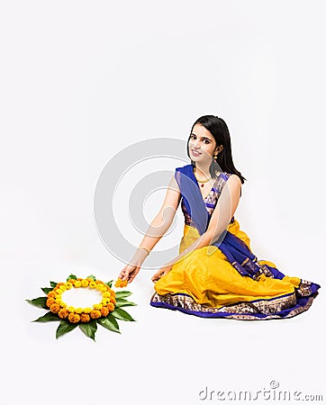 Indian woman making rangoli using flowers Stock Photo