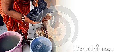 Indian woman washing cloths by hands or manually in plastic water bucket with copy space Stock Photo