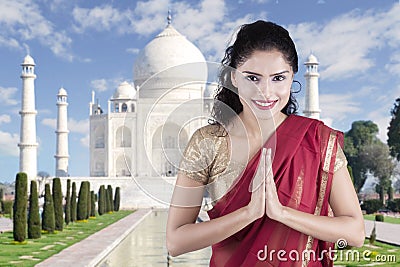 Indian woman with welcome gesture in Taj Mahal Stock Photo