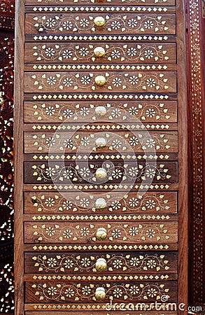 Indian wooden cabinet with drawers with golden inlay and round handles Stock Photo