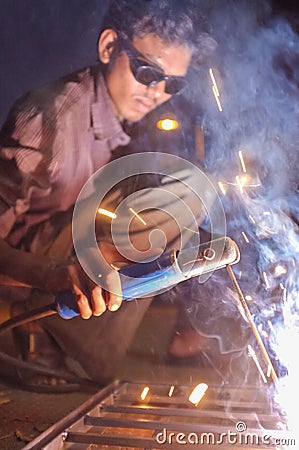 Indian worker welding Editorial Stock Photo