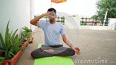Indian young boy meditating at home. Portrait of Asian cute boy practicing yoga on home background. Worldwide yoga day concept Stock Photo