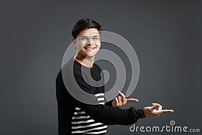 Indian young man showing direction with hand Stock Photo