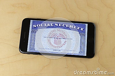 Social Security card blank on a smartphone. The Social Security Administration oversees retirement, disability benefits Editorial Stock Photo