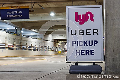 Lyft and Uber pickup spot at the airport. Lyft and Uber ride sharing has replaced many Taxi cabs for transportation I Editorial Stock Photo