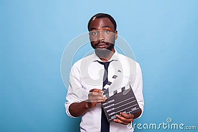 Indie african american movie producer with open clapperboard in hands Stock Photo
