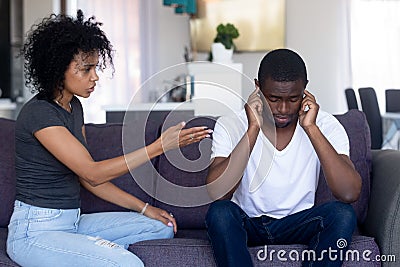 Indifferent black husband ignore pushy wife lecturing Stock Photo