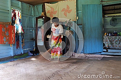 Indigenous Fijian woman cleans her home in Fiji Editorial Stock Photo