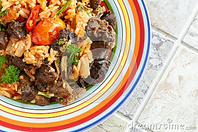 Indigenous Ghanaian, African-Caribian food Jollof Rice with tomato sauce, regional spices, chicken meat and offal Stock Photo