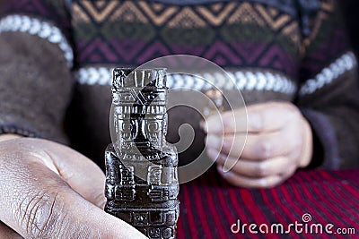 the indigenous man's hand holds a monolith, . Tiwanaku Stock Photo