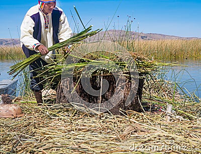 Indigenous man working on the traditional village of the floating Uros Islands Editorial Stock Photo