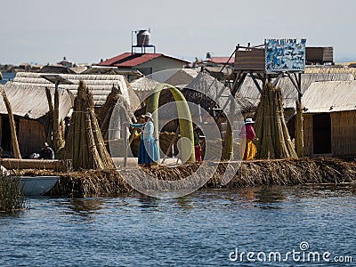 Indigenous women in colorful traditional dresses on Uros Floating reed Islands on Lake Titicaca Puno Peru South America Editorial Stock Photo