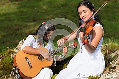 Indigenous women with instruments singing in nature Stock Photo