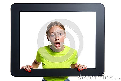 Indignant girl peeking through digital tablet frame Stock Photo