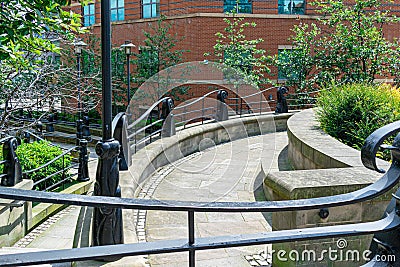 Inding roads and steps in Newcastle city centre with green trees and vibrant colourful flowers, stone and brick walls Editorial Stock Photo