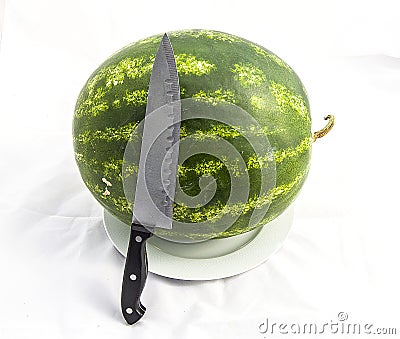 Indispensable fruit of summer months watermelon, waiting for you to be cut with a knife Stock Photo