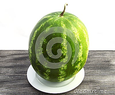 Indispensable fruit of summer months watermelon, waiting for you to be cut with a knife Stock Photo