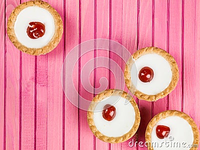 Individual Bakewell Tarts On A Pink Background Stock Photo