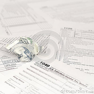 1040 Individual income tax return form and crumpled hundred dollar bill Editorial Stock Photo