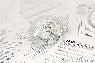 1040 Individual income tax return form and crumpled hundred dollar bill Editorial Stock Photo