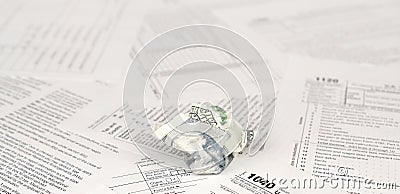 1040 Individual income tax return form and crumpled hundred dollar bill Editorial Stock Photo