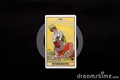 An individual major arcana tarot card isolated on black background. Strength. Stock Photo