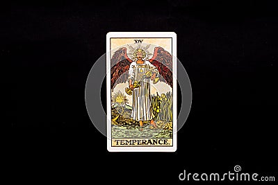 An individual major arcana tarot card isolated on black background. Temperance. Stock Photo