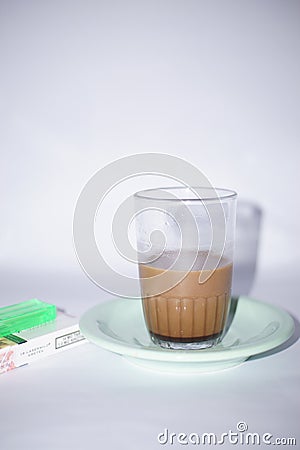 indonesia, jakarta, 2023 february 27, a glass of coffee and a pack of cigarettes, is on the table, Editorial Stock Photo