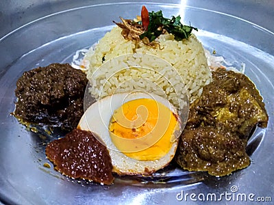 Indonesia traditional food samin rice with egg, rendang beef and chicken curry Stock Photo