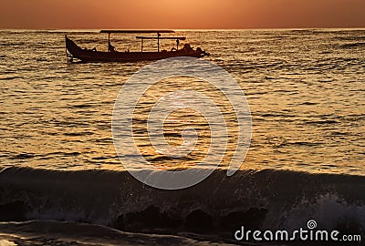Indonesian boats in ocean at sunset Stock Photo