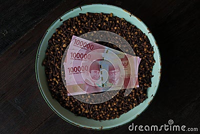 Indonesian Currency with clove Stock Photo