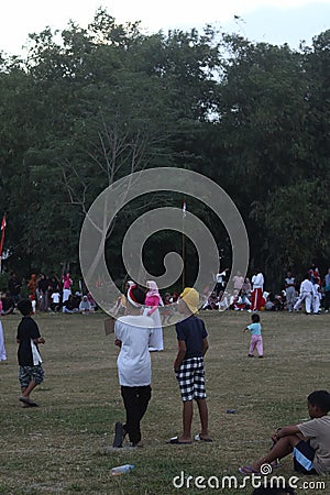 The Indonesian flag lowering ceremony witnessed by villagers. Indonesia Independence Day Editorial Stock Photo