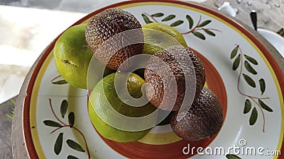 Indonesian fruit, Orange, and Salak. The fruit on the plate. Stock Photo