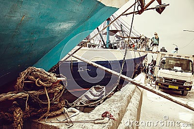 Indonesian port workers unload a ship with a flour bags cargo in Editorial Stock Photo