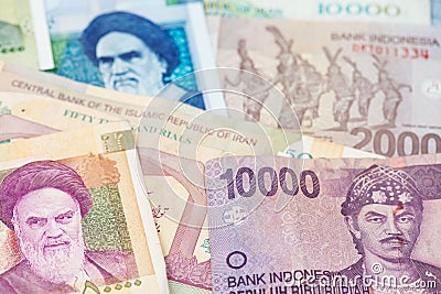Indonesian Rupiah and Iranian Rial Currency. Stock Photo