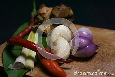 Indonesian special spices that are on a wooden cutting board are ready to be cooked and consist of shallots, garlic, chilies Stock Photo