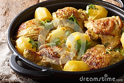 Indonesian spicy chicken coconut curry with potatoes close-up in a frying pan. horizontal Stock Photo