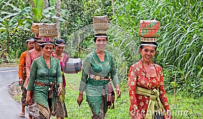 Indonesian women carry offerings in baskets Editorial Stock Photo