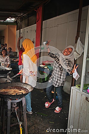 Indonesian women laughing whilst cooking, Medan, Indonesia Editorial Stock Photo