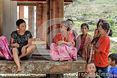 Indonesian women sit under the floor of tongkonan traditional house in Tana Toraja Editorial Stock Photo