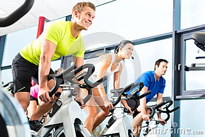 Indoor bycicle cycling in gym Stock Photo