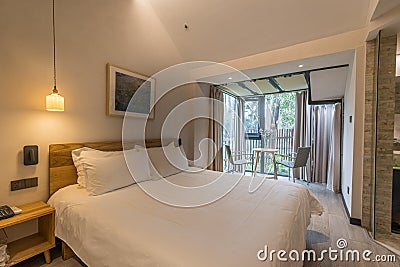 Indoor hotel room and floor-to-ceiling windows with forest view Editorial Stock Photo