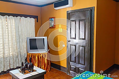 Indoor hotel room view with TV and A/C Editorial Stock Photo