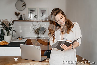 indoor picture of smiling woman with documents and pen Stock Photo