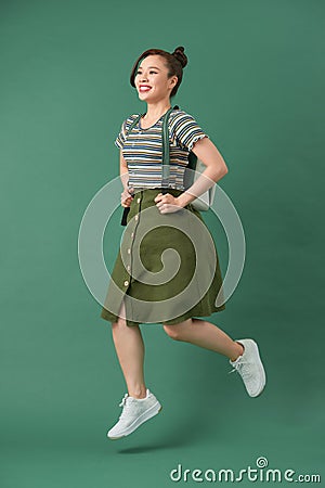 Indoor picture of young good-looking teenage girl isolated on green background Stock Photo