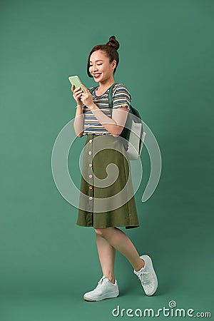 Indoor picture of young good-looking teenage girl isolated on green background Stock Photo
