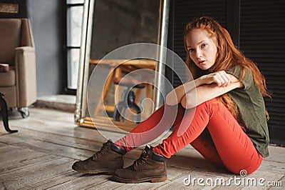 Indoor portrait of beautiful young redhead woman Stock Photo