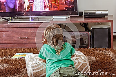 Indoor portrait of young boy watching tv Stock Photo