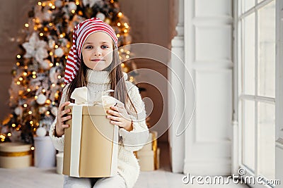 Indoor shot of pleasant looking small kid with blue charming eye Stock Photo